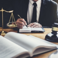male-lawyer-or-judge-working-with-contract-papers-5ZV28KL.jpg